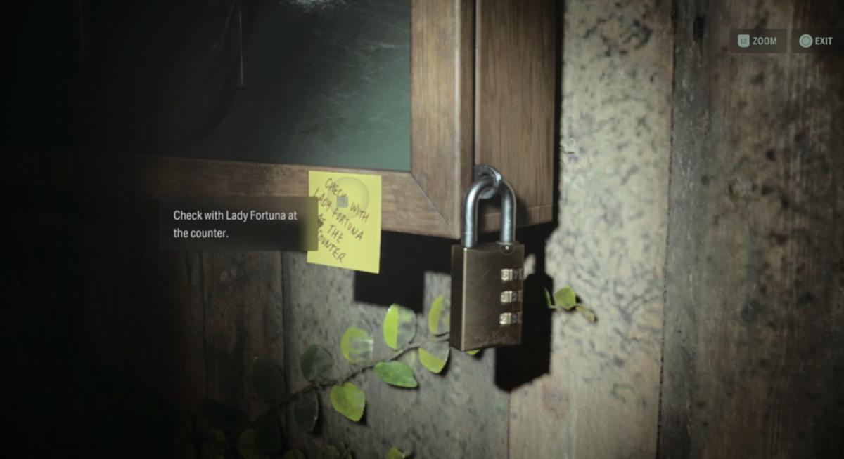 A lock hanging off a display case with a sticky note attached.